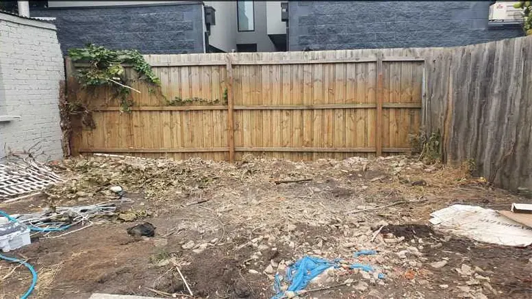 After: the same backyard with the brick rubble and debris removed