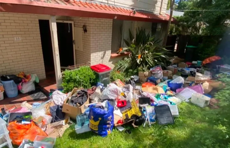 Before: household items, bags and boxes spread across a front lawn